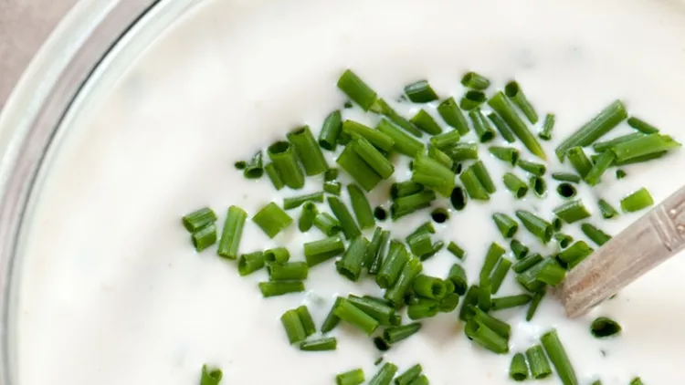glass-jar-of-homemade-ranch-dressing-with-chives-from-above-picture-id487811945