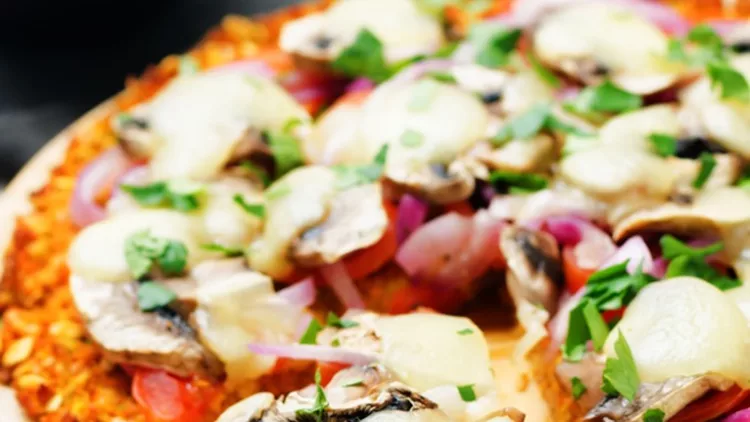 sweet-potato-pizza-crust-with-tomato-red-onion-and-mushrooms-picture-id667311422