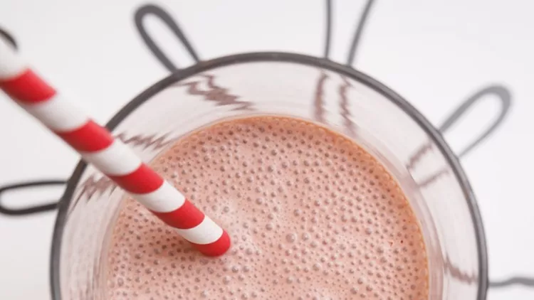 top-view-of-a-strawberry-protein-or-milk-shake-in-a-glass-with-straw-picture-id1145521281