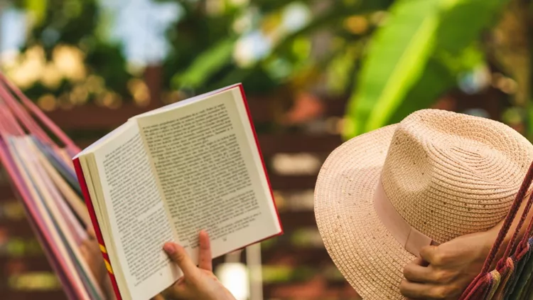 attractive-sexy-woman-reading-book-in-hammock-picture-id1145393520