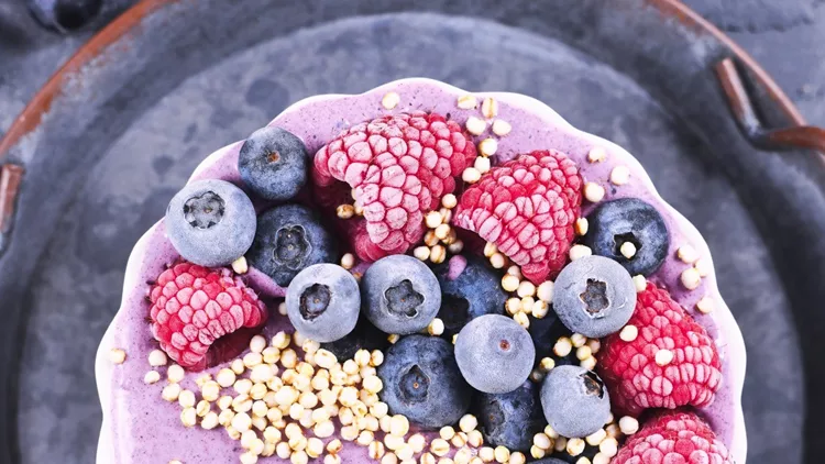 fruit-smoothie-bowl-with-yogurt-decorated-with-healthy-raspberry-and-picture-id1211925078