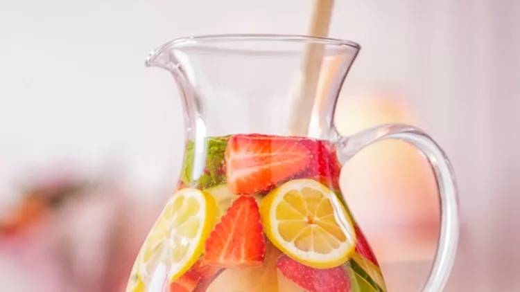 infused-water-with-fresh-strawberries-lime-lemon-and-basil-picture-id585083856