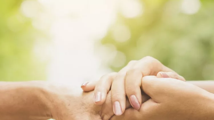 daughter-holding-her-mothers-hand-outdoors-picture-id1012950914