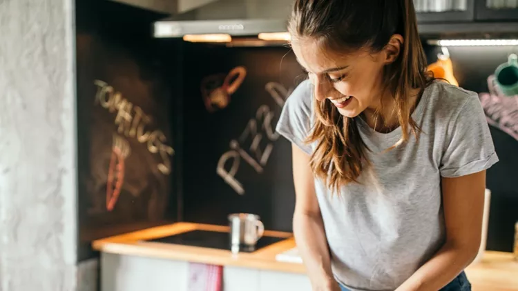 young-woman-preparing-pizza-picture-id1049042926