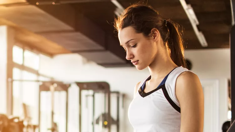 tired-fitness-woman-resting-after-morning-training-in-gym-picture-id598674642