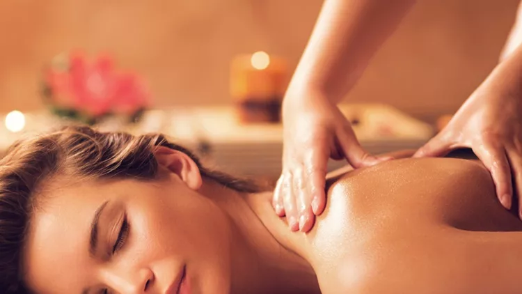 young-woman-relaxing-during-back-massage-at-the-spa-picture-id469916170