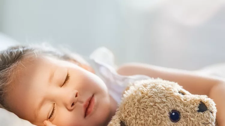 child-is-sleeping-in-the-bed-picture-id1169555658