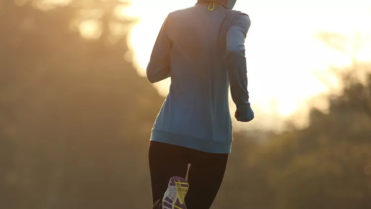 young-fitness-woman-runner-running-on-sunrise-road-picture-id1156227790