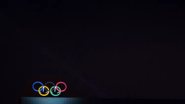 Olympic symbol (also known as Olympic Rings) seen on the Montreal olympic Committee building lit during a dark night. Montreal became an olympic city with the 1976 Summer Olympic Games
