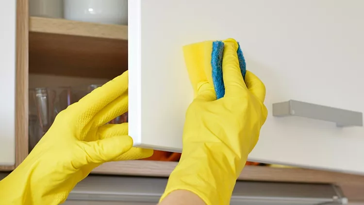 woman-in-yellow-gloves-washes-the-door-in-kitchen-cabinet-picture-id1139715687