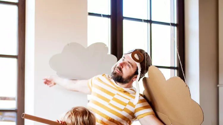 toddler-boy-and-father-with-carton-plane-playing-indoors-at-home-picture-id1151630677