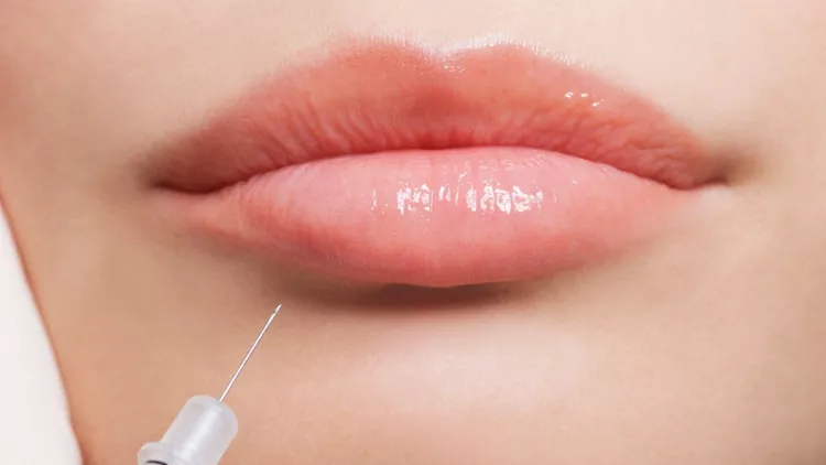 close-up-of-woman-receiving-botox-injection-in-lips-picture-id147206877