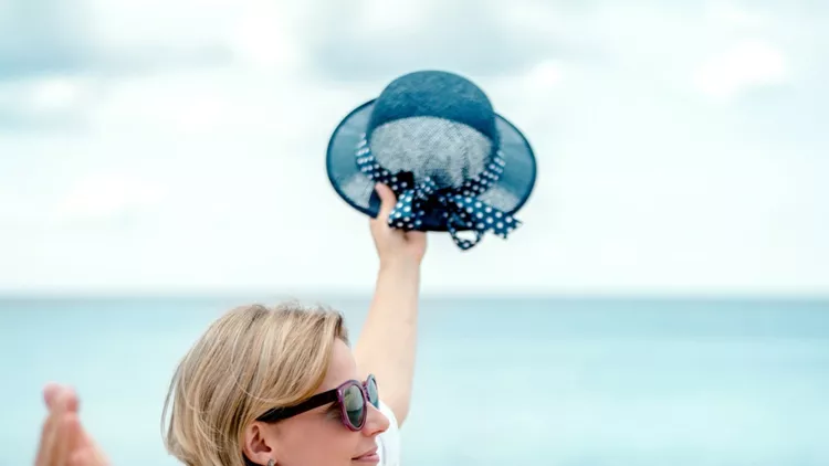 happy-mature-woman-at-the-seaside-picture-id1198852544