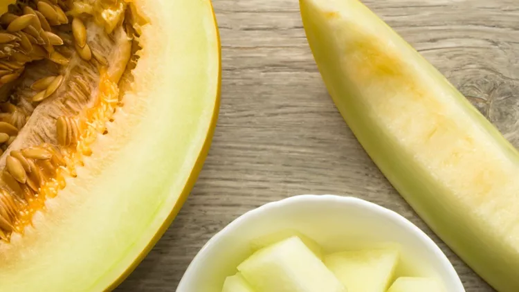 sliced-melon-in-white-dish-directly-above-view-picture-id543047694