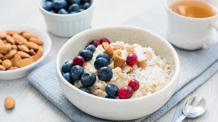 Oatmeal porridge bowl with blueberries, cranberries and almonds