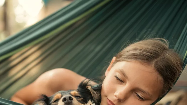 girl-relaxing-in-hammock-with-her-dog-picture-id1148388194 (1)