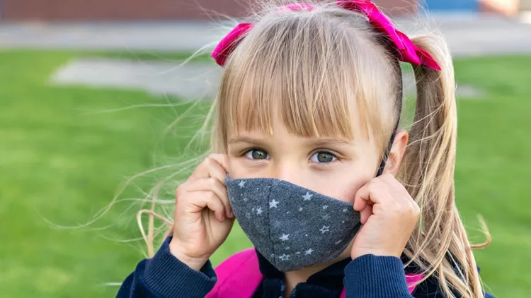 young-student-caucasian-girl-wearing-protective-cotton-mask-for-to-picture-id1256537754