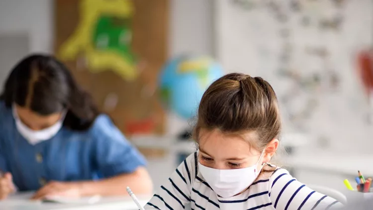 children-with-face-mask-back-at-school-after-covid19-quarantine-and-picture-id1250037717
