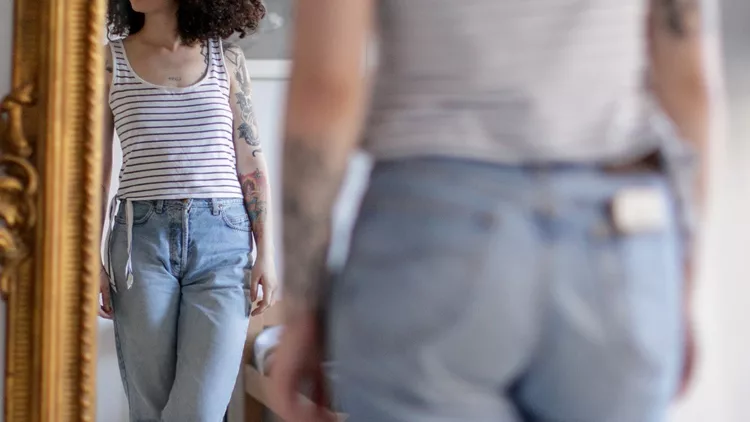 reflection-of-young-tattooed-woman-in-the-mirror-picture-id1148990473