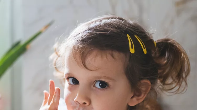 cute-little-girl-eating-whipped-cream-picture-id1175724144