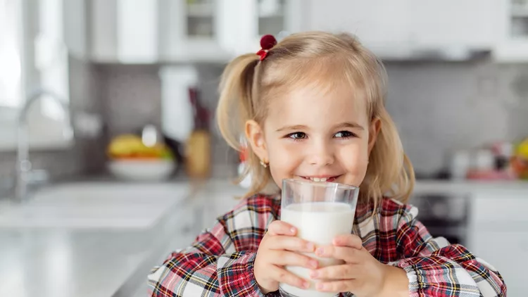 Female child drinking glass of milk