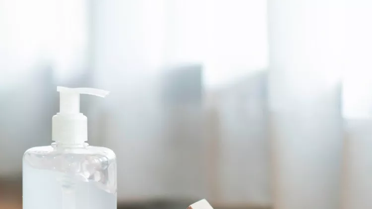 alcohol-hand-gel-sanitizer-with-medical-protective-mask-and-wooden-picture-id1223162969