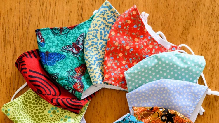 homemade-protective-face-masks-with-colourful-fabrics-picture-id1253842692