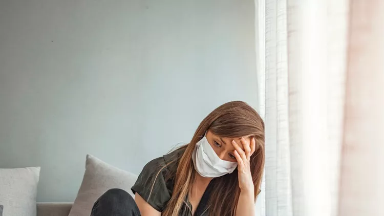sad-lonely-girl-isolated-stay-at-home-in-protective-sterile-medical-picture-id1217033251