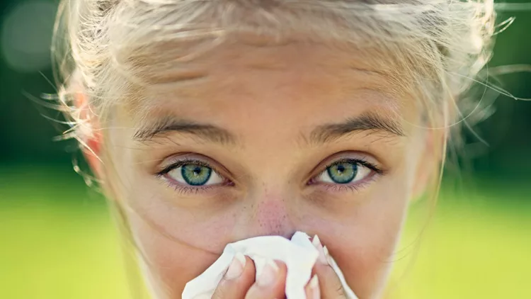 teenage-girl-with-allergy-blowing-nose-picture-id1180201800