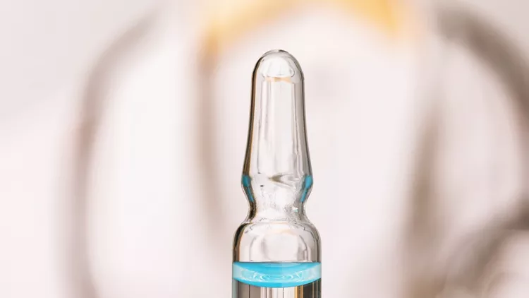 ampoule-with-a-vaccine-from-the-new-coronavirus-covid19-on-the-of-a-picture-id1206607143