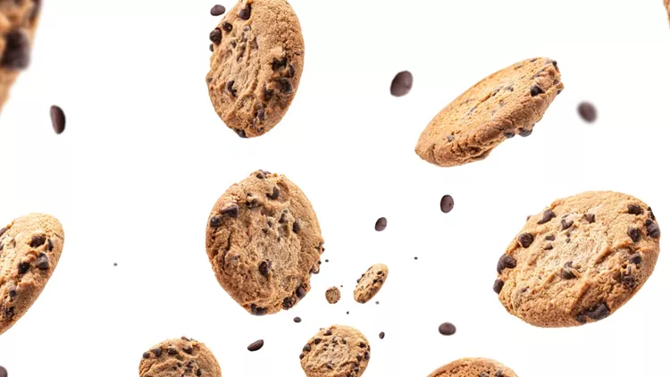 chocolate-chip-cookie-falling-isolated-on-white-background-selective-picture-id1212905292