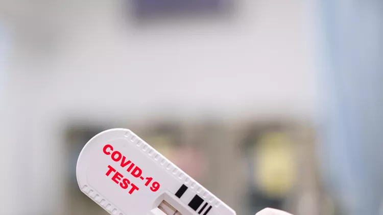 doctor-hand-holding-positive-coronavirus-or-covid19-rapid-test-picture-id1214307672