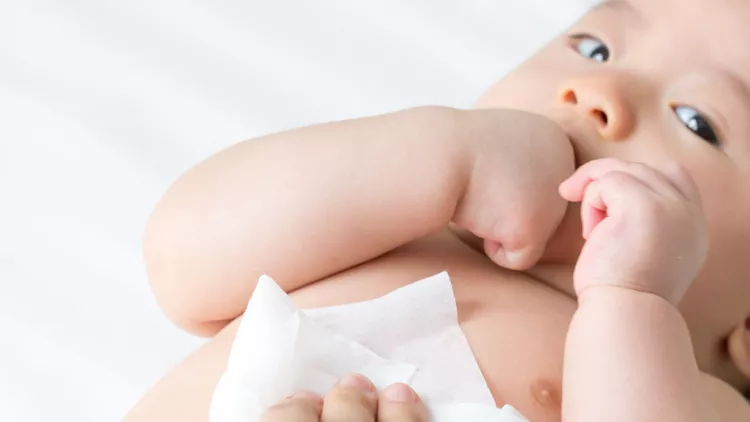 mom-cleaning-up-and-wipe-body-baby-by-wet-tissue-when-changing-or-picture-id1091625348
