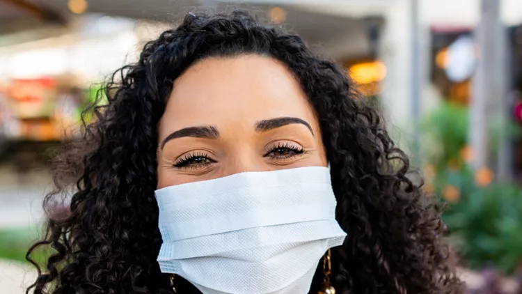 smiling-woman-behind-face-protection-mask-picture-id1264534020