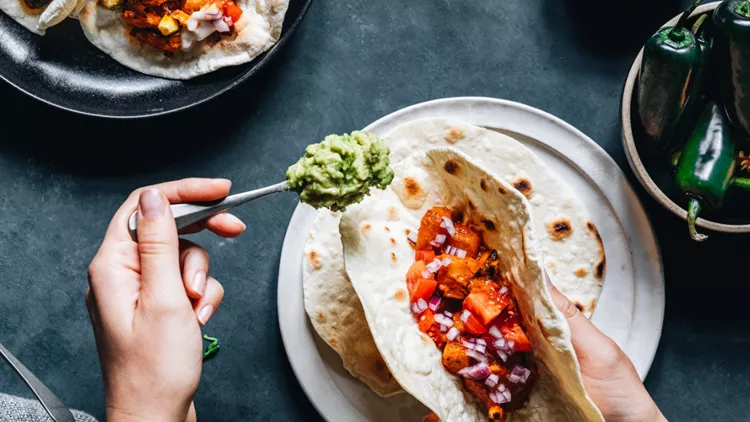 woman-preparing-tasty-vegan-tacos-picture-id1241880776 (1)