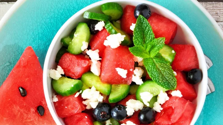 watermelon-salad-with-cucumber-blueberries-and-cheese-top-view-scene-picture-id1154482254