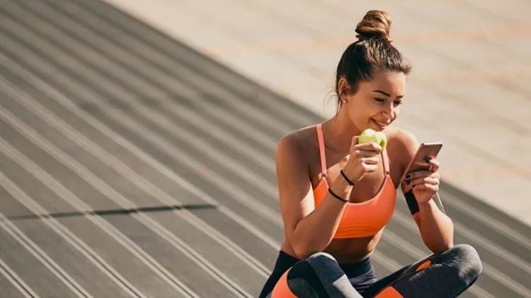 portrait-of-girl-sitting-on-stairs-after-exercising-picture-id935551910