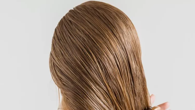 woman-in-the-white-towel-with-comb-brushing-her-wet-blonde-hair-after-picture-id858536580