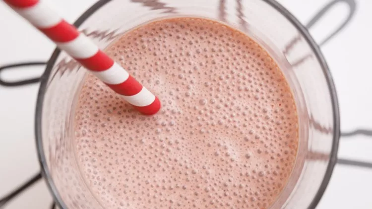 top-view-of-a-strawberry-protein-or-milk-shake-in-a-glass-with-straw-picture-id1145521281