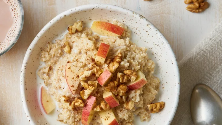 oatmeal-with-apple-nuts-honey-and-cup-of-chocolate-on-white-wooden-picture-id1152612386