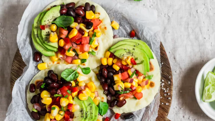 spicy-bean-tortillas-with-corn-salsa-and-avocado-picture-id622442874