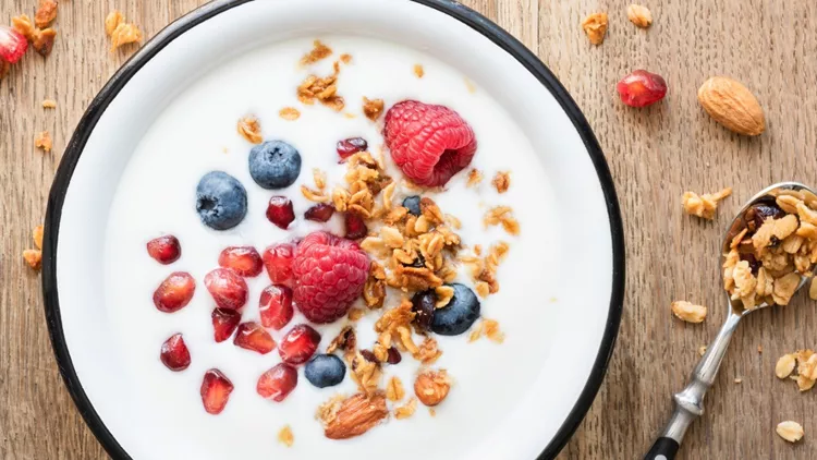 greek-yogurt-with-granola-and-berries-on-wooden-table-picture-id1013814238