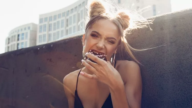 portrait-of-funny-beautiful-girl-eating-donut-picture-id590143918