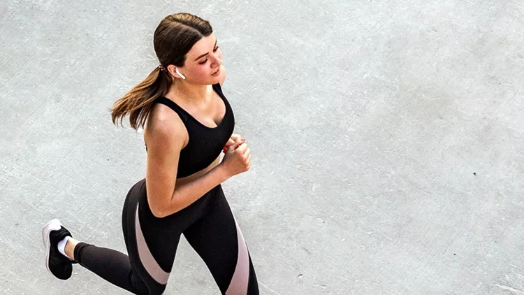 top-view-of-young-attractive-athletic-woman-speed-running-on-city-picture-id1158473465