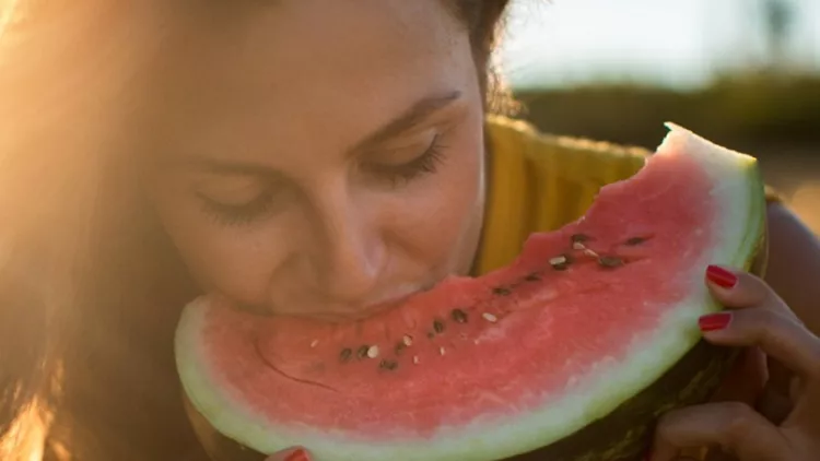 young-woman-eating-watermelon-outdoors-picture-id599145152