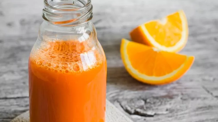 fresh-carrotorange-juice-in-a-glass-bottle-picture-id484137564