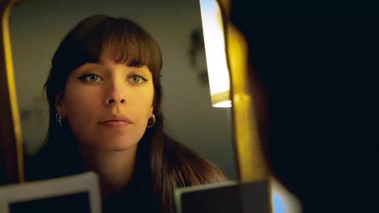 woman looking at the mirror